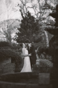 Bride and groom in gardens black and white