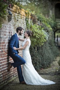 Bride and groom by wall talking