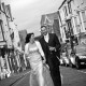 Bride and groom walking along the road