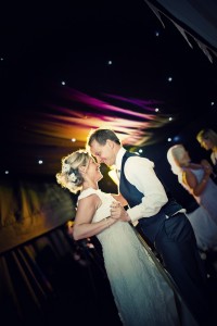 Bride and groom dancing at night venue