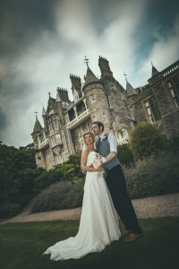 Bride and groom in front of castle